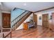 Finished basement with home office and wooden staircase at 11498 Pauls Ln, Conifer, CO 80433