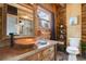 Rustic bathroom with copper sink and wood vanity at 11498 Pauls Ln, Conifer, CO 80433