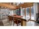 Open concept dining room with a large wooden table and kitchen views at 11498 Pauls Ln, Conifer, CO 80433