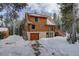 Mountain log home with attached garage and snowy driveway at 11498 Pauls Ln, Conifer, CO 80433