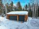 Two-car garage with wood exterior and snow covered ground at 11498 Pauls Ln, Conifer, CO 80433