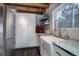 White kitchen cabinets, farmhouse sink, and green countertops at 11498 Pauls Ln, Conifer, CO 80433