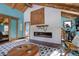 Relaxing living room with a fireplace and a view into the bathroom at 11498 Pauls Ln, Conifer, CO 80433