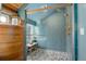 Large walk-in shower with herringbone tile and gold fixtures at 11498 Pauls Ln, Conifer, CO 80433