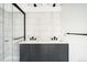Modern bathroom featuring a double vanity, sleek fixtures, tile backsplash and a glass enclosed shower at 5780 W 92 Ave, Westminster, CO 80031