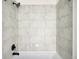 Neutral-toned tile shower and tub featuring modern fixtures and clean lines at 5780 W 92 Ave, Westminster, CO 80031