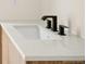 Modern bathroom sink featuring matte black hardware, white countertop, and sleek design at 5780 W 92 Ave, Westminster, CO 80031