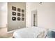 Modern bedroom featuring artistic wall decor and a glimpse into an organized walk-in closet at 5780 W 92 Ave, Westminster, CO 80031