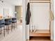 Hallway area features a wooden hall tree, leading into the kitchen with barstool seating at 5780 W 92 Ave, Westminster, CO 80031