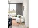 A modern living room with a sectional sofa, stylish rug, and a large window for natural light at 5780 W 92 Ave, Westminster, CO 80031