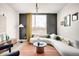 Bright living room with a stylish sofa, modern decor, and large window views at 5780 W 92 Ave, Westminster, CO 80031