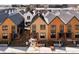 New construction showing modern townhomes in light brown with black trim at 5780 W 92 Ave, Westminster, CO 80031