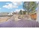 This back deck includes white wood railings and is surrounded by mature trees and neighborhood scenery at 8743 Fairview Oaks Ln, Lone Tree, CO 80124