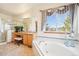 Bathroom with a tub, vanity, large mirror, and separate glass-enclosed shower at 8743 Fairview Oaks Ln, Lone Tree, CO 80124