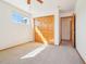 Bedroom with light carpet, a window, and a closet with wooden doors at 8743 Fairview Oaks Ln, Lone Tree, CO 80124