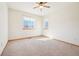 Bedroom featuring light carpet, neutral walls, two windows, and a ceiling fan at 8743 Fairview Oaks Ln, Lone Tree, CO 80124