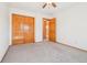 Bedroom with light carpet, a window, and a closet with wooden doors at 8743 Fairview Oaks Ln, Lone Tree, CO 80124