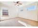 Bedroom with neutral carpet, three windows, and a ceiling fan at 8743 Fairview Oaks Ln, Lone Tree, CO 80124