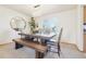 Bright dining room featuring a modern chandelier, table with bench, and an octagonal mirror at 8743 Fairview Oaks Ln, Lone Tree, CO 80124