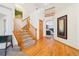 Open entryway with hardwood floors, staircase and entry to the living room at 8743 Fairview Oaks Ln, Lone Tree, CO 80124