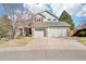 Charming two-story home with a three-car garage, stone accents, and a well-maintained front yard at 8743 Fairview Oaks Ln, Lone Tree, CO 80124