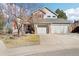 Charming two-story home with a three-car garage, stone accents, and a well-maintained front yard at 8743 Fairview Oaks Ln, Lone Tree, CO 80124