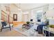 Bright living room with hardwood floors, a staircase, and large windows at 8743 Fairview Oaks Ln, Lone Tree, CO 80124