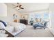 Primary bedroom showcasing a sitting area, ceiling fan, and a view to the en-suite at 8743 Fairview Oaks Ln, Lone Tree, CO 80124