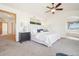 Primary bedroom showing a bed, neutral walls and carpet, and an en-suite at 8743 Fairview Oaks Ln, Lone Tree, CO 80124