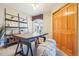 Home office featuring a large wooden desk, ladder shelving, and comfortable seating at 8743 Fairview Oaks Ln, Lone Tree, CO 80124