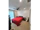 Spacious bedroom with ample natural light, featuring plush red bedding at 2010 S Holly St # 3, Denver, CO 80222