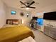 Well-lit bedroom with ceiling fan and modern desk setup, perfect for work or relaxation at 2010 S Holly St # 3, Denver, CO 80222