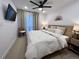 Serene main bedroom featuring a ceiling fan, TV, and large window at 2010 S Holly St # 3, Denver, CO 80222