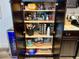 Organized walk-in pantry with shelves of spices, cookware and a beverage cooler at 2010 S Holly St # 3, Denver, CO 80222