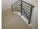Modern staircase with sleek railing and plush carpeting for added comfort and style at 2010 S Holly St # 3, Denver, CO 80222