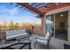 Spacious patio with pergola and outdoor furniture, offering city views at 8524 Gold Peak Dr # B, Highlands Ranch, CO 80130