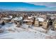 Aerial view of house and neighborhood in winter setting at 1128 Starglow Pl, Highlands Ranch, CO 80126