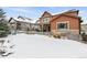 Spacious backyard with patio, fire pit, and snow-covered lawn at 1128 Starglow Pl, Highlands Ranch, CO 80126