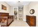 Bedroom with wood crib, dresser, and closet, offering ample storage and comfort at 1128 Starglow Pl, Highlands Ranch, CO 80126