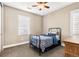 Neutral bedroom with a black metal bed frame, a window with shutters, and carpeted floors at 1128 Starglow Pl, Highlands Ranch, CO 80126