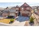 Beautiful two-story home with stone accents, attached garage and landscaped front yard at 1128 Starglow Pl, Highlands Ranch, CO 80126