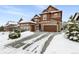 Two-story house with a three-car garage and basketball hoop at 1128 Starglow Pl, Highlands Ranch, CO 80126