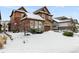 Two-story house with snow-covered front yard and driveway at 1128 Starglow Pl, Highlands Ranch, CO 80126