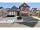 Two-story home with stone and shingle accents, attached garage, and snow-covered landscaping at 1128 Starglow Pl, Highlands Ranch, CO 80126