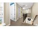 Neutral hallway with carpeted floors leading to multiple rooms and a staircase with dark metal railings at 1128 Starglow Pl, Highlands Ranch, CO 80126