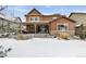 Two story house exterior, brown siding, snowy backyard at 1128 Starglow Pl, Highlands Ranch, CO 80126