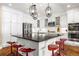 Modern kitchen with white cabinets, stainless steel appliances, and a large island at 1128 Starglow Pl, Highlands Ranch, CO 80126