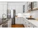 White kitchen with stainless steel appliances and white subway tile backsplash at 1128 Starglow Pl, Highlands Ranch, CO 80126