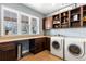 Convenient laundry room with washer, dryer, and ample cabinetry at 1128 Starglow Pl, Highlands Ranch, CO 80126