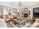 Open living room with a stone fireplace and large windows at 1128 Starglow Pl, Highlands Ranch, CO 80126